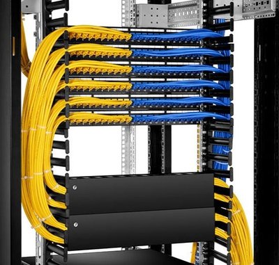 Professional network cable management with yellow fiber optic and blue ethernet cables in server rack